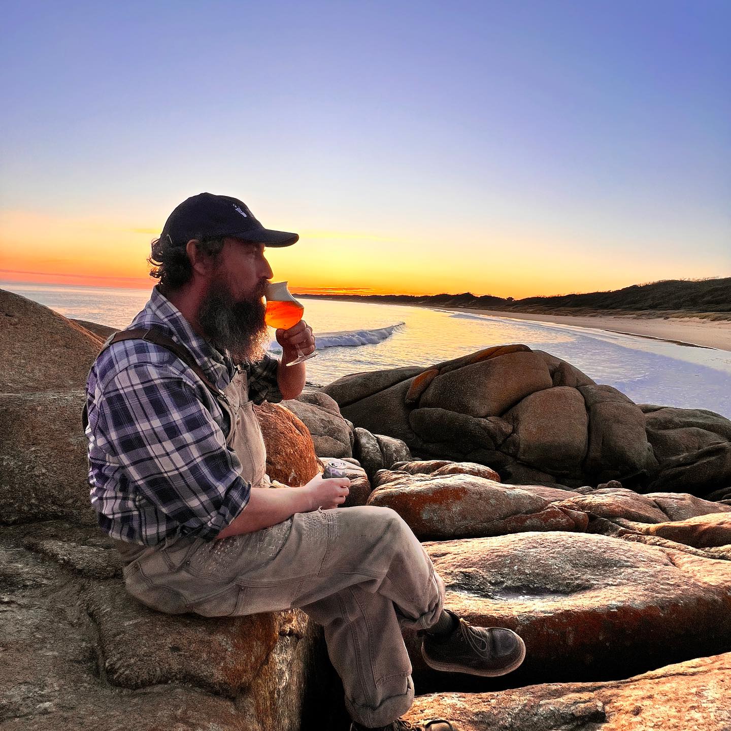 Sailors Grave Brewing Chris drinking beer on a rock at Cape Conran West Cape at sunset