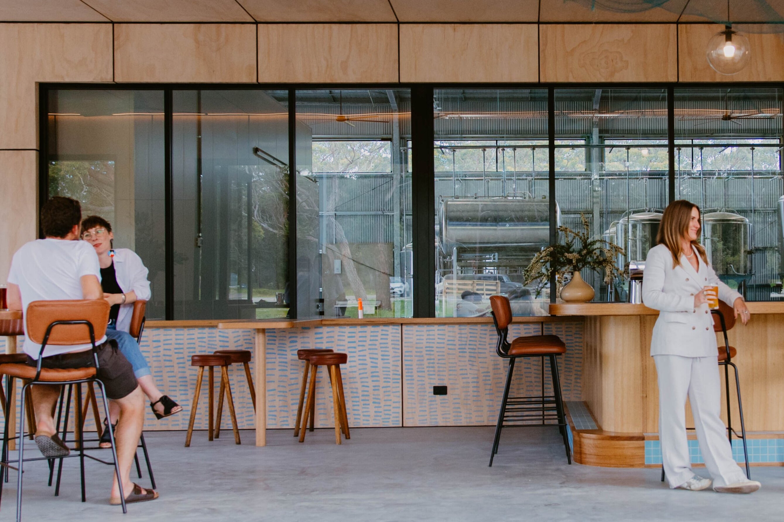People sitting at Sailors Grave Brewing Dunetown bar enjoying craft beers.