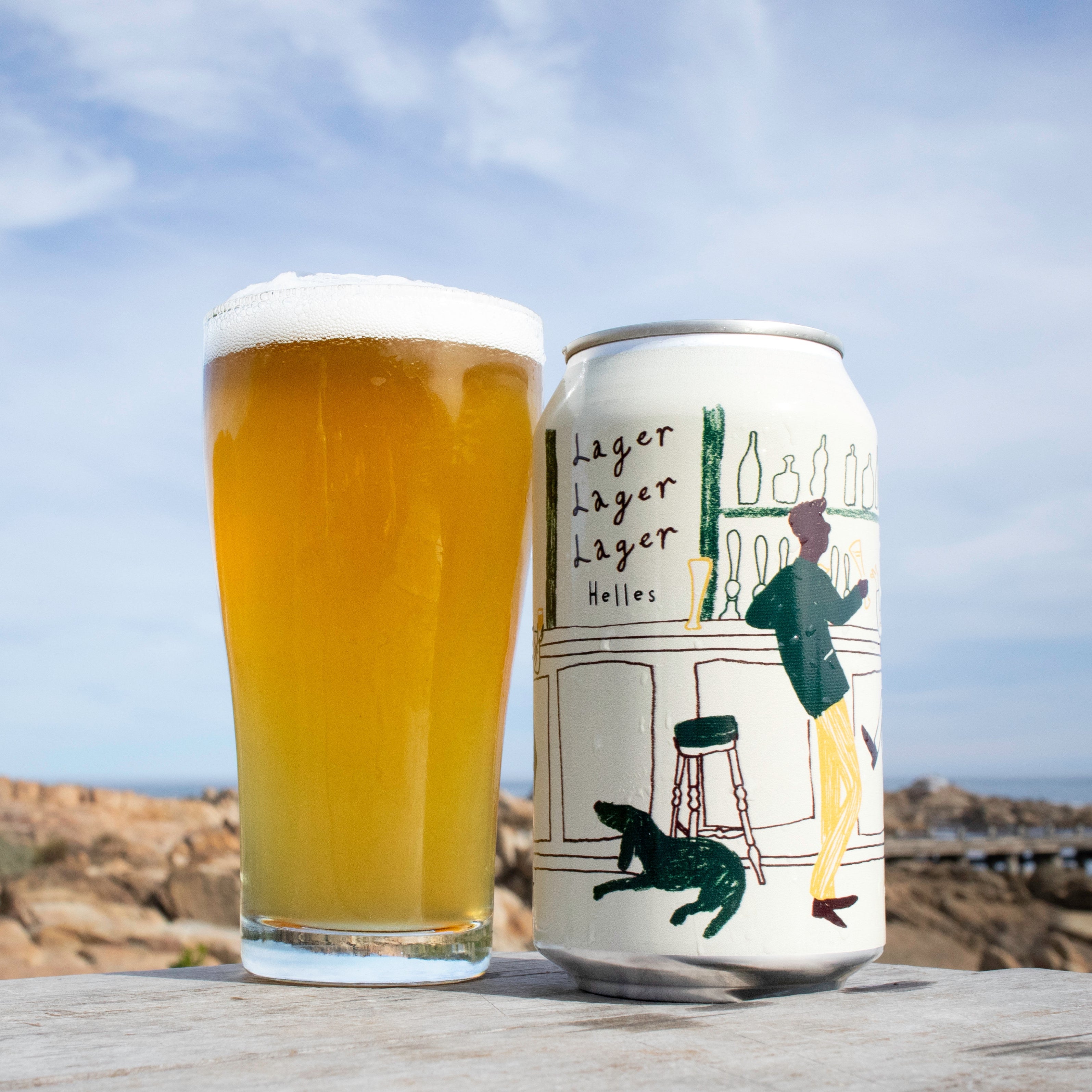 Beer can and glass with 'Lager Lager Lager' branding against a scenic background